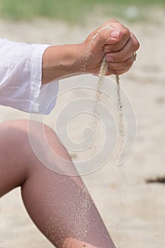 close-up of girl& x27;s hand throws sand