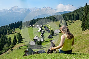 CLOSE UP: Girl shares a loving moment with dog during hiking trip in Julian Alps