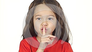 Close-up girl shows emotion of silence at white background. Slow motion