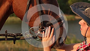 Close-up of a girl stroking a horse in the face.