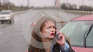 Close-up of the girl talking on the phone after a car accident.