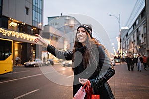 Close-up of girl wearing hat waving for cab