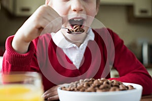 Close Up Of Girl Wearing School Uniform Eating Bowl Of Sugary Br