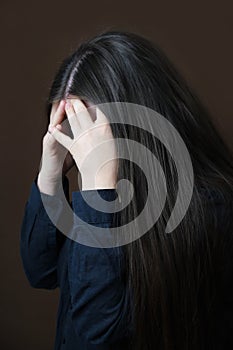 Close-up girl, woman under pressure of various life problems in despair covered her face, which was distorted by protest, concept