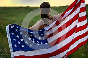 Close-up of a girl wrapped in the flag of america