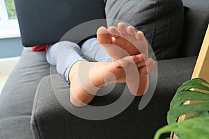 Close up of girls feet on sofa