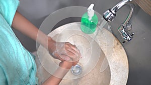 close up of girls hands washing hands with running water