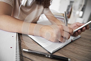 Close up of girlâ€™s hand writing on notebook