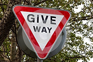 Close up of Give Way sign with trees in background Birkenhead Wirral August 2019