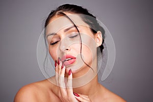 Close up glamorous woman with red manicure and bare shoulders