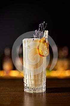 Close up glass of Alcoholic cocktail, classic Cuban rum, spiced liqueur and cream and a slice of orange