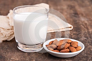 Close Up glass of Almond milk with Almond seeds. Almond milk in a glass with almonds