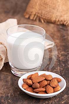 Close Up glass of Almond milk with Almond seeds. Almond milk in a glass with almonds