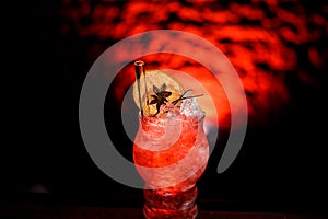 Close-up of glass with bright cocktail decorated with slices of citrus