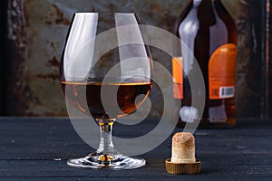Close up of glass cognac or whiskey on rusty background