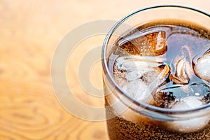 Close up Glass filled with carbonated cola soft drink with ice cubes. selective focus