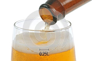 Filling a glass of fresh lager beer close-up