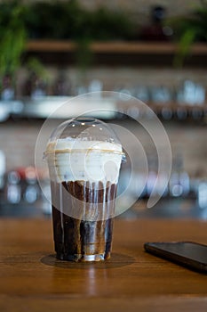 Close up glass of iced cold brew coffee topped with cream cheese