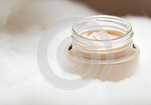 Close up Glass jar with beige cream