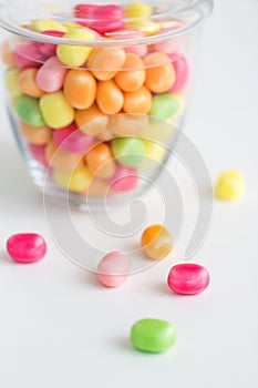 Close up of glass jar with colorful candy drops