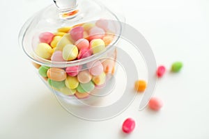 Close up of glass jar with colorful candy drops