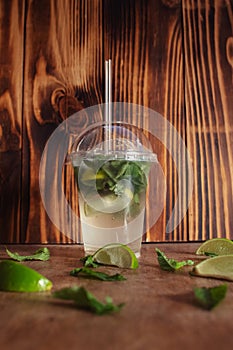 Close-up of a glass with lemonade or mojito cocktail. Summer drink with ice, juice and soda. Cooling during heat. Cocktail