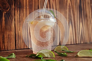 Close-up of a glass with lemonade or mojito cocktail. Summer drink with ice, juice and soda. Cooling during heat. Cocktail