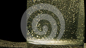 Close up of a glass of mineral sparkling water. Stock footage. Mineral water with bubbles inside the transparent glass