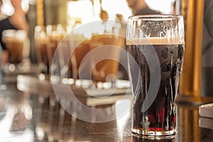 Close up of a glass of stout beer in a bar