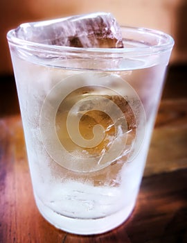Close up a glass of watet with ice tube