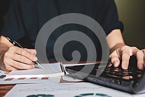 Close-up glasses is Asian young business man of student holding a pen writing letter on paper at home