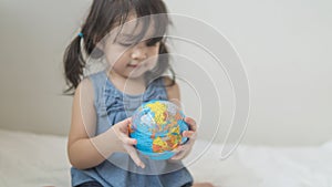 Close-up of globe ball in asian toddler hands