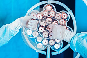 Close-up of gloved hands holding surgical scissors