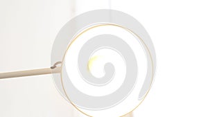 Close-up of glowing bulb with floor lamp. Media. Lamp with open round plafond included on white background. Lighting