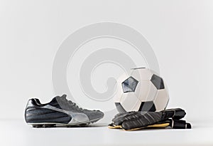Close up of goalkeeper gloves, ball, soccer boots