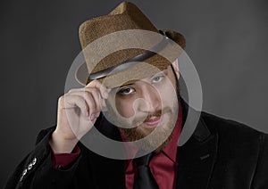Close up Goatee Man Holding his Brown Hat