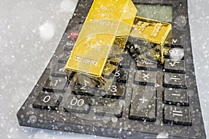 Close up gold bars on calculator