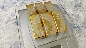 Close up gold bars on precision scales