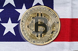 Close up Gold Bitcoin coin on usa flag