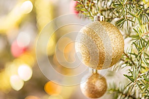 Close-up of gold Christmas ball hanging on Christmas tree