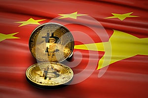 Close-up gold colored bitcoin coin on china flag