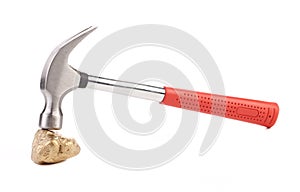 Close up of gold nugget and hammer.