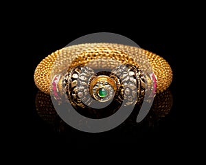 Close up of golden bangle with many diamonds