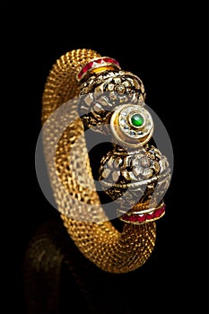 Close up of golden bangle with many diamonds