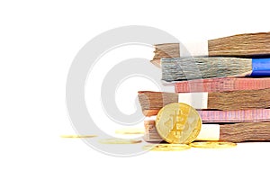 Close up golden bitcoin coin and many banknotes on white background. Cryptocurrency symbol. The shiny bitcoin gold coin stands out