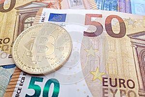 Bitcoin on top of a stack of Euro banknotes