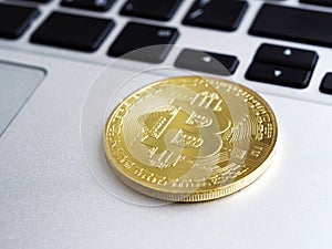 Close-up of Golden Bitcoin on laptop