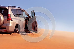 Close up of a golden car stuck in the sand in the Namib desert. Walvis Bay. Namibia. Africa