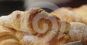 Close-up of golden croissants in a bakery. Tipical breakfast with croissant and coffee, food conception