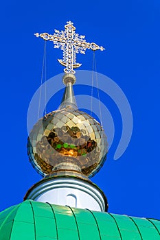Close-up of golden cross on dome of orthodox church